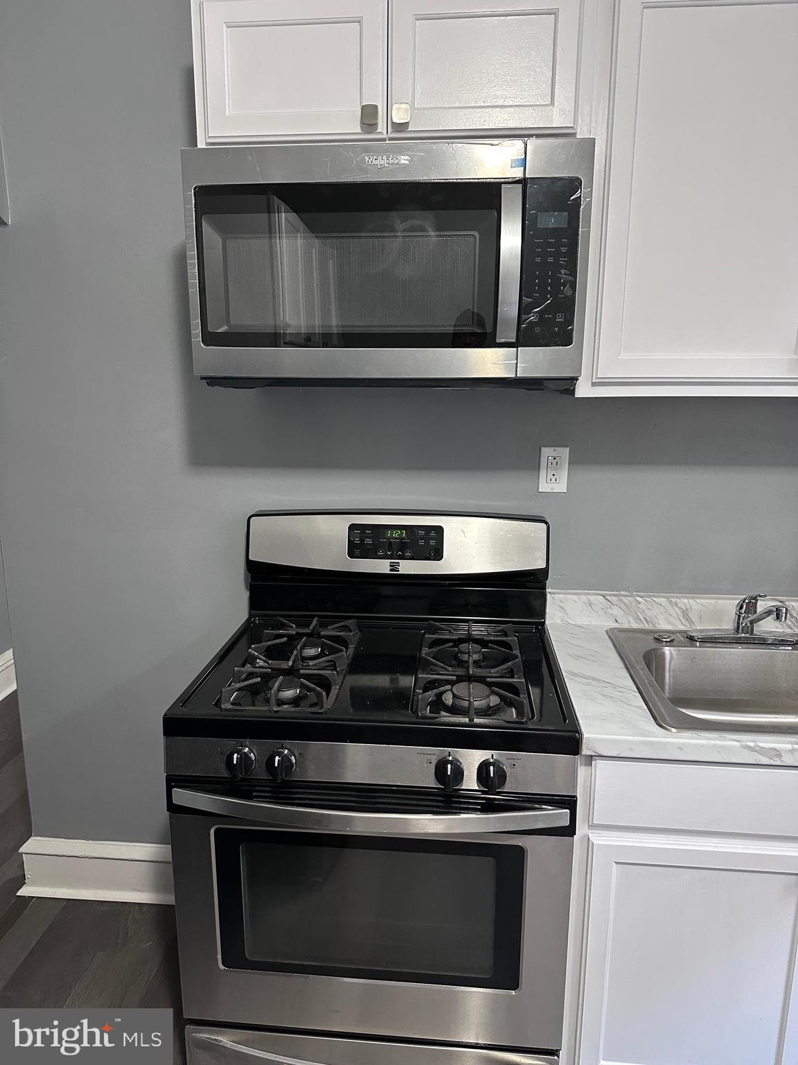 a stove top oven sitting inside of a kitchen