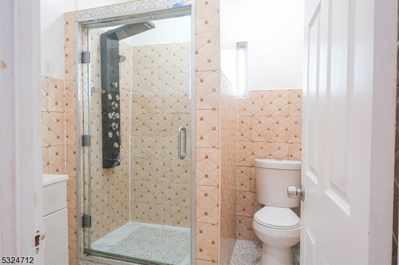 a bathroom with a shower toilet and sink