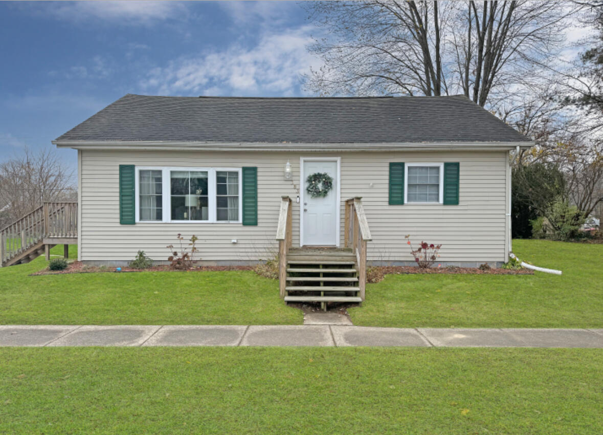 a front view of a house with a garden