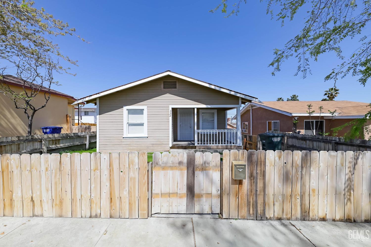 a front view of a house with wooden fence