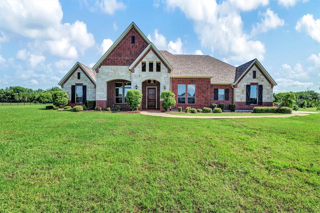 a front view of house with yard and green space