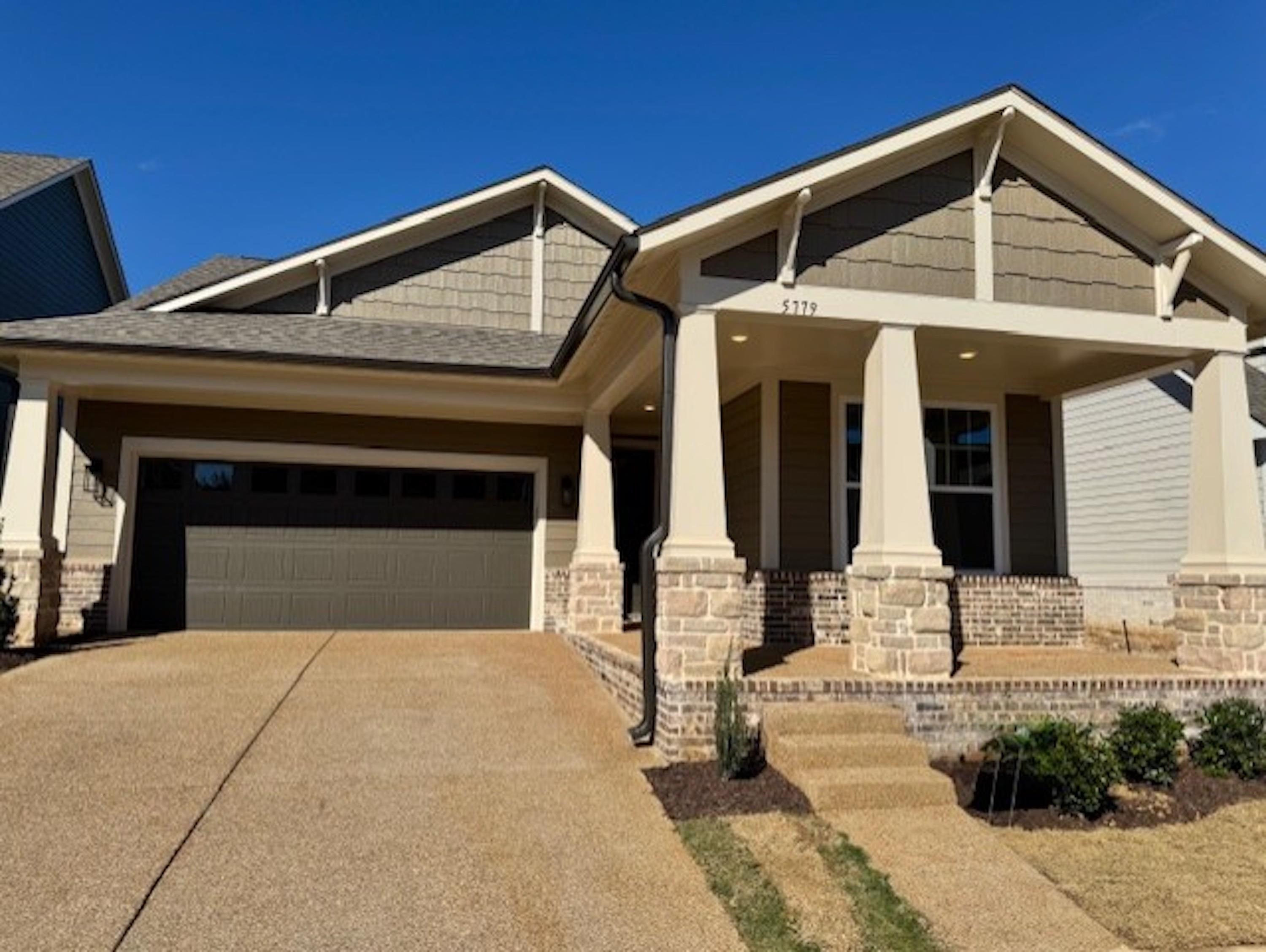 a front view of a house with garage