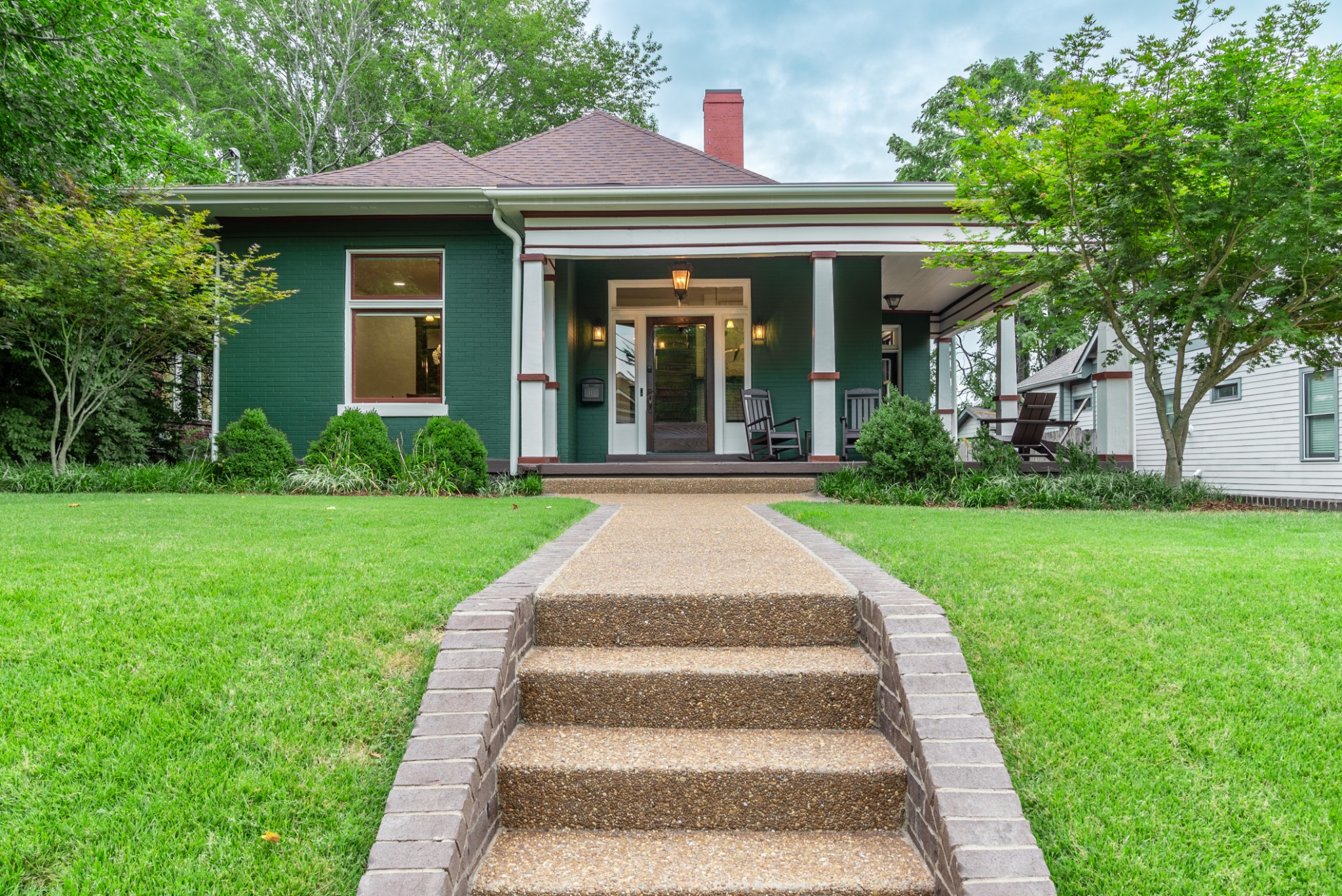 a front view of a house with garden