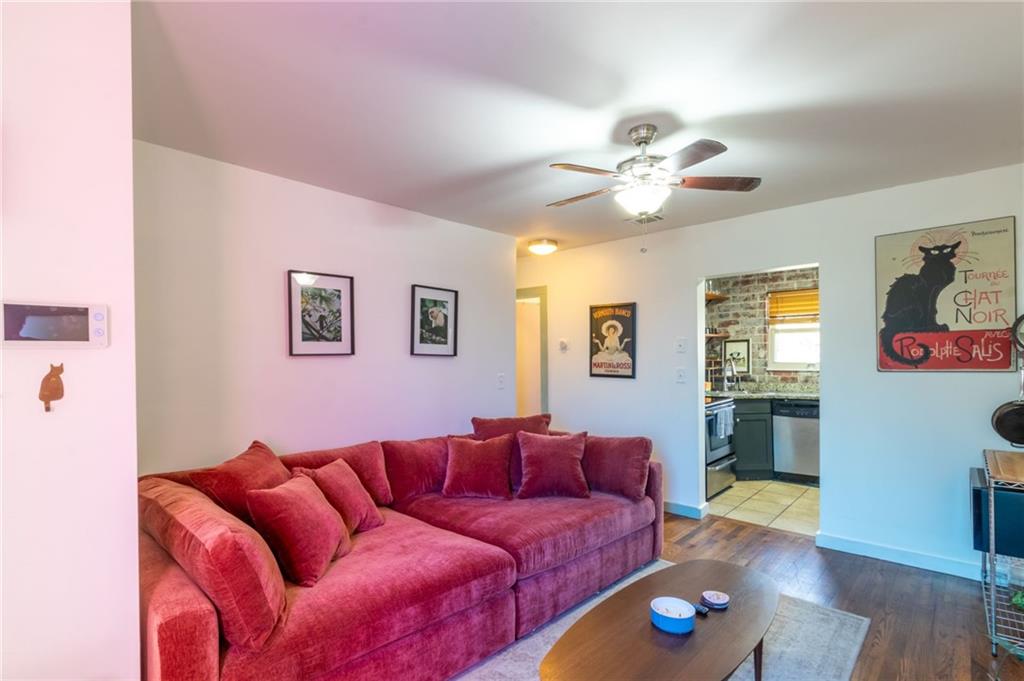 a living room with furniture and wooden floor