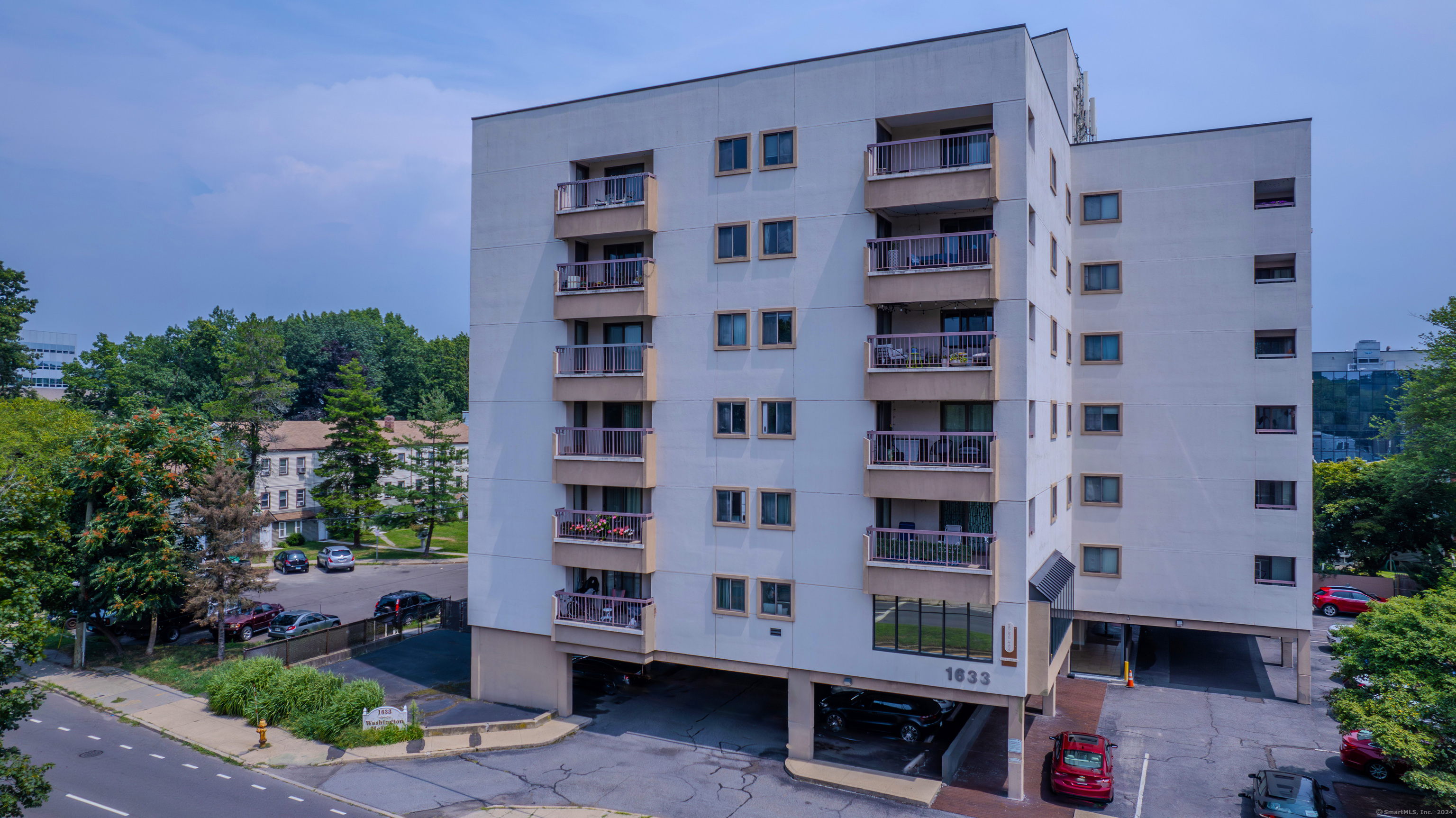 a front view of a building with a garden