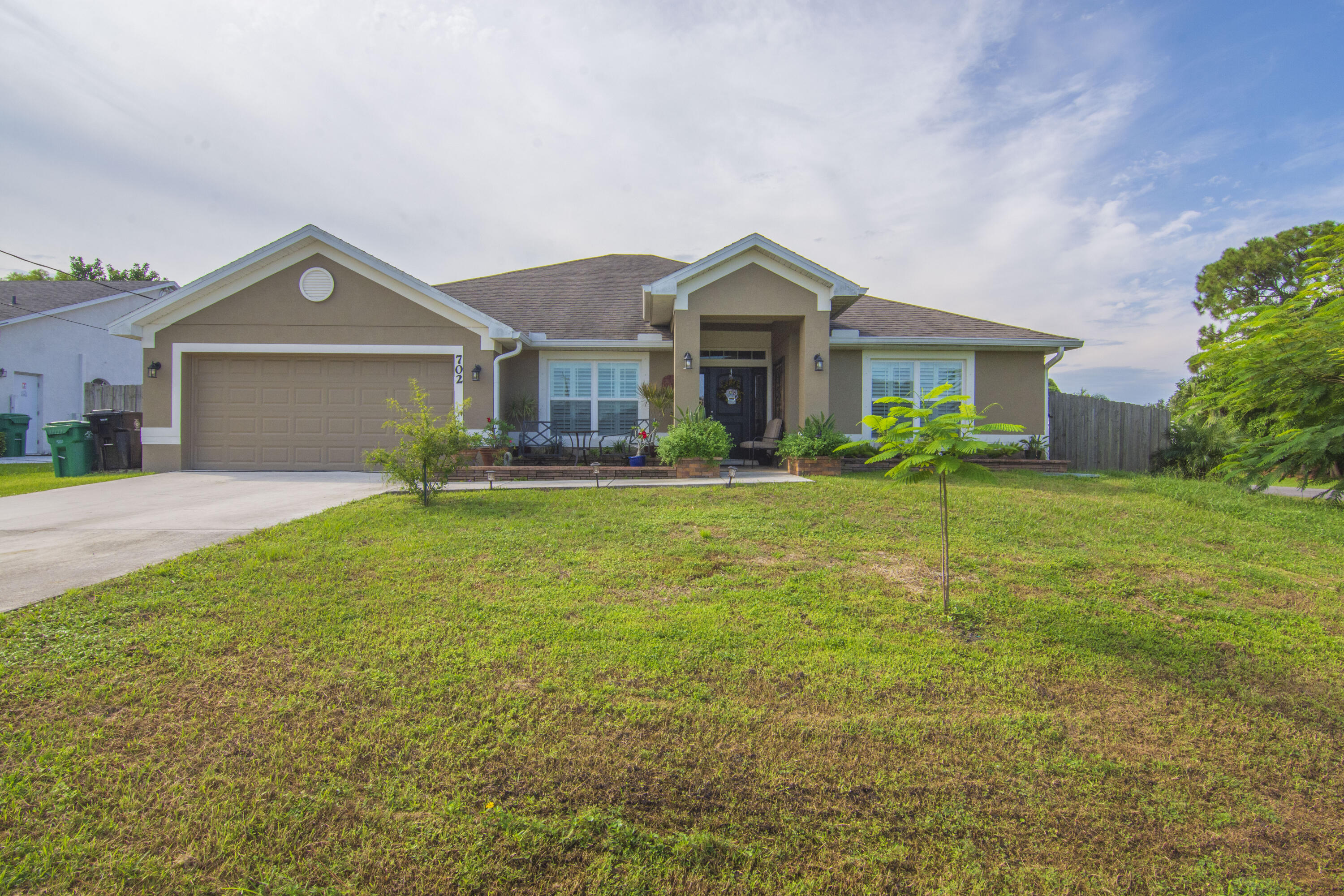 a front view of house with yard and green space