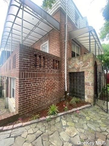 a view of a brick house with many windows