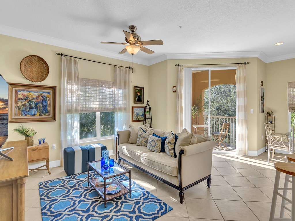 a living room with furniture a flat screen tv and a large window