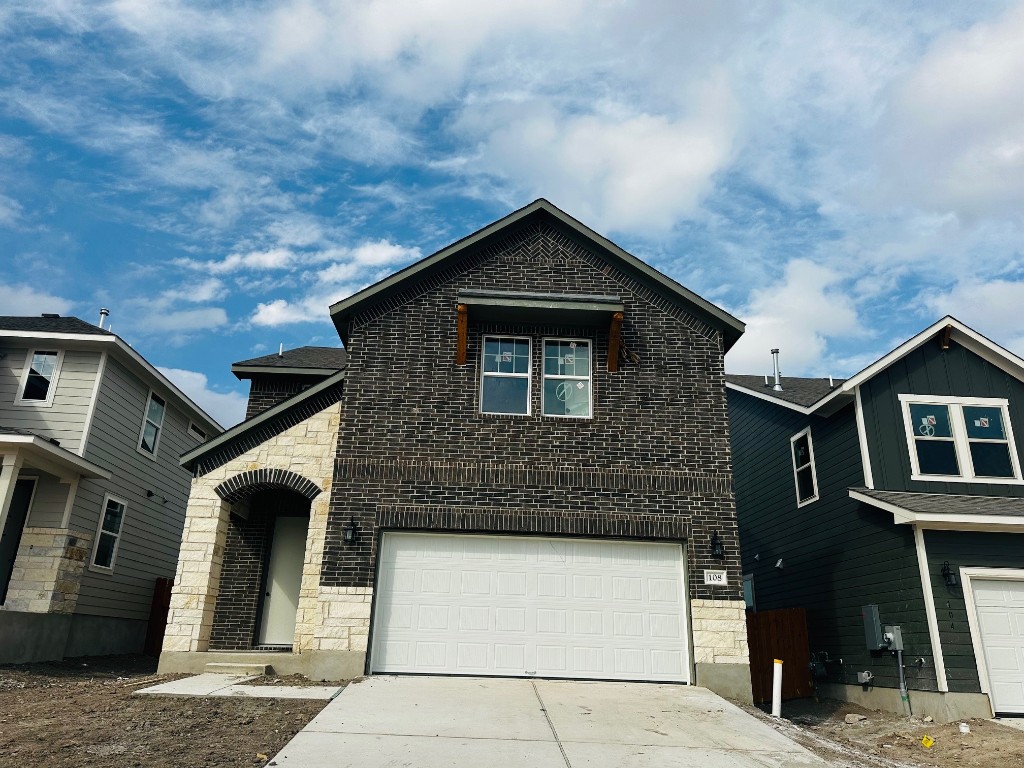 a front view of a house with garage