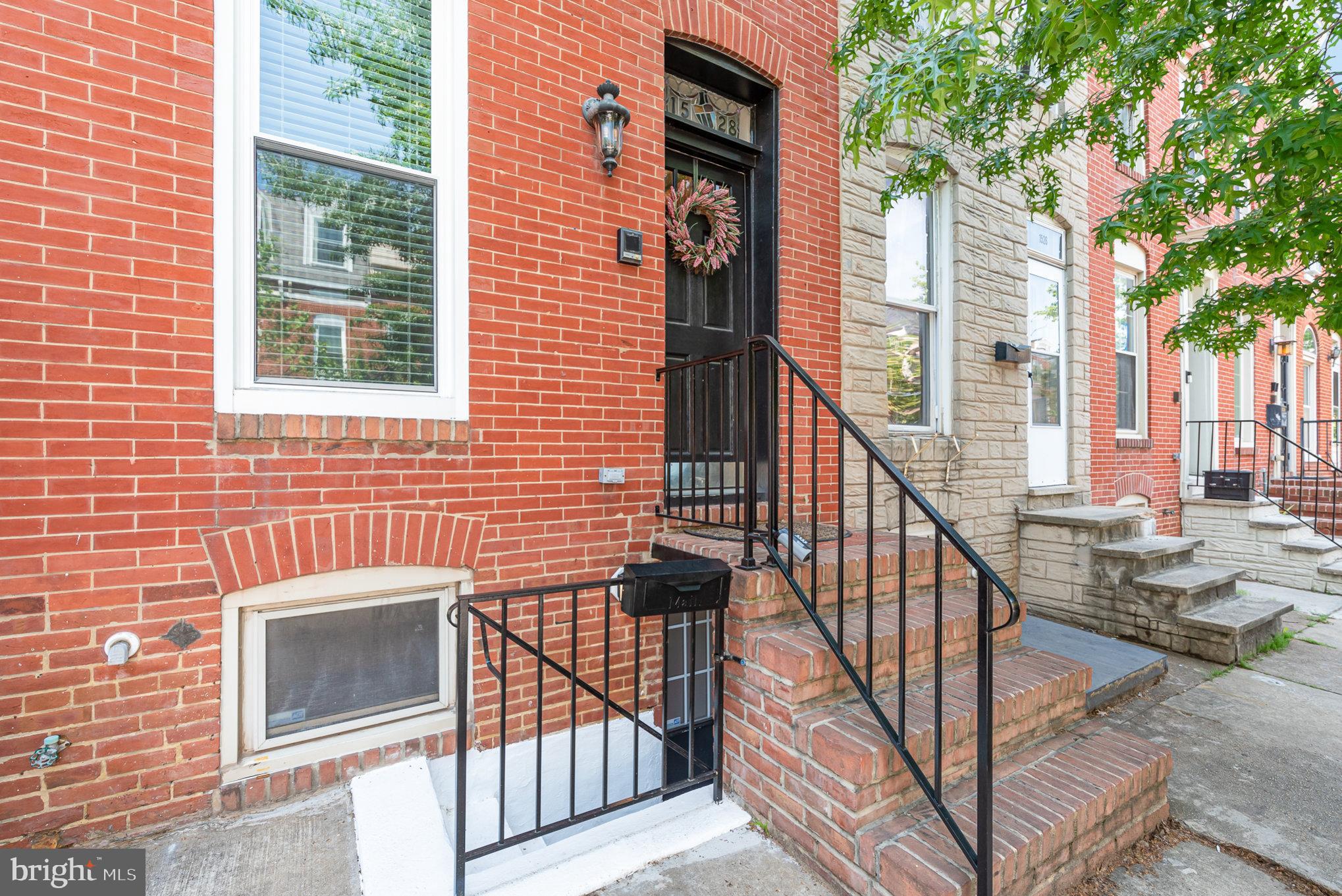 a view of front door and porch with wooden floor