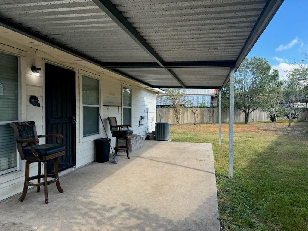 a view of a porch with chairs and a yard