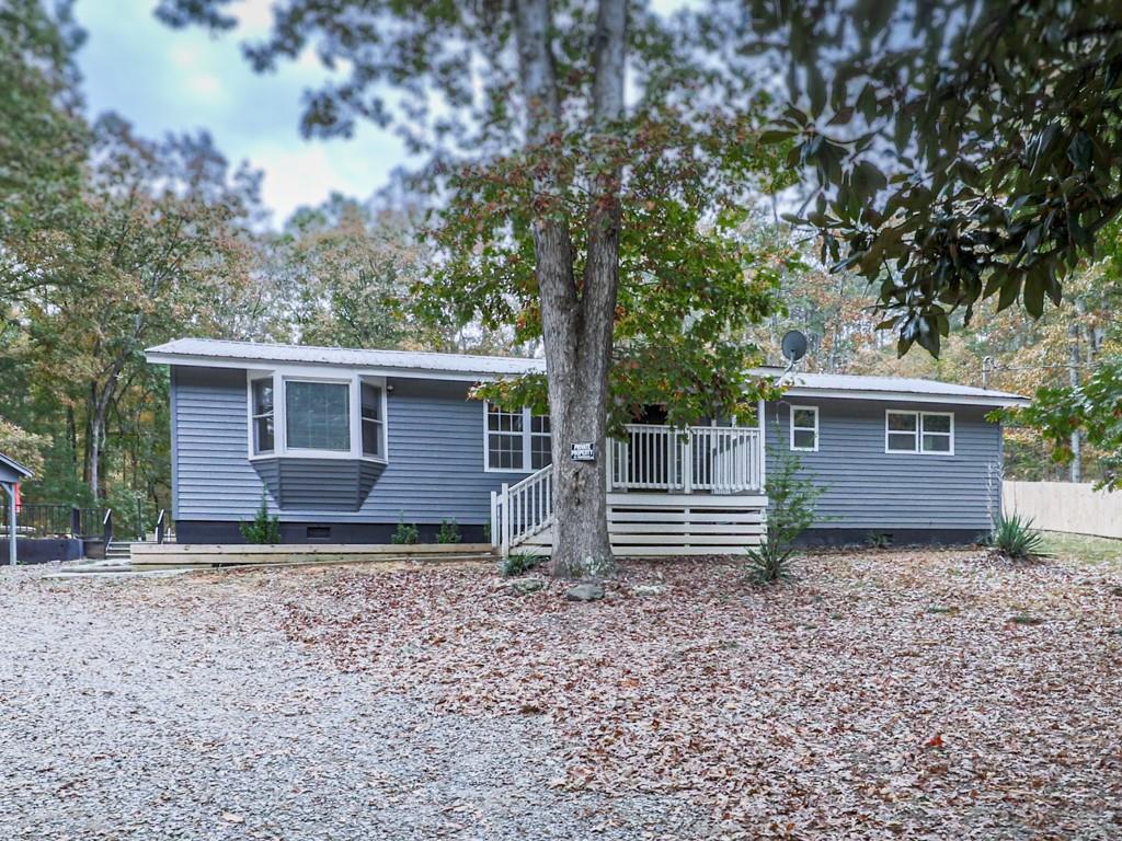 a view of house with backyard and trees