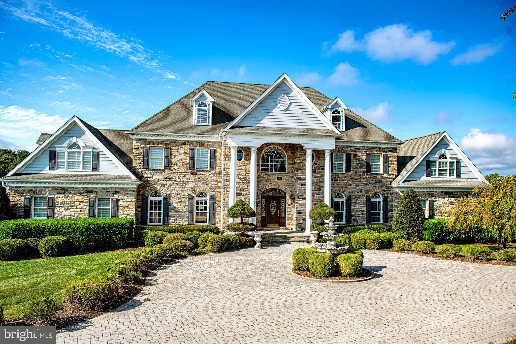 a front view of a house with a garden and porch