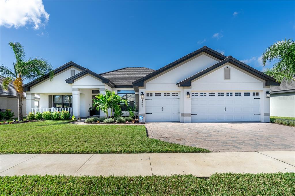 a front view of a house with a yard and garage