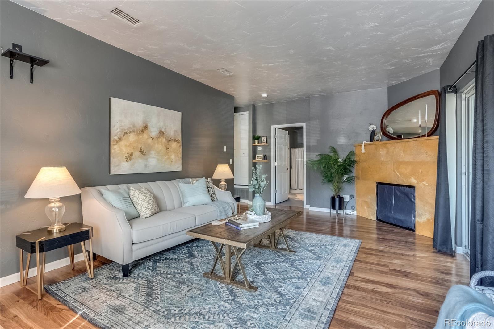 a living room with furniture and a fireplace