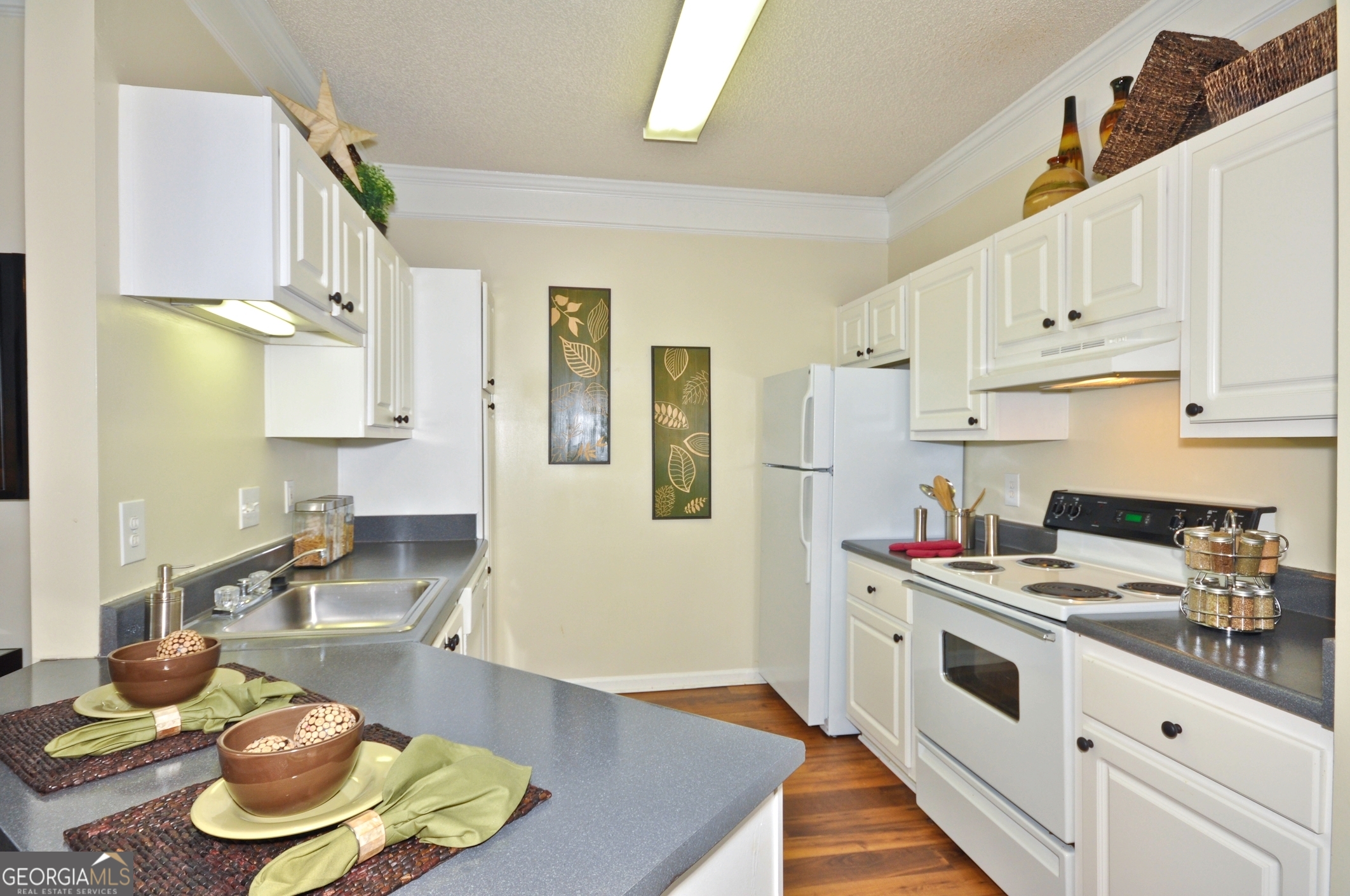 a kitchen with stainless steel appliances a stove a sink and cabinets