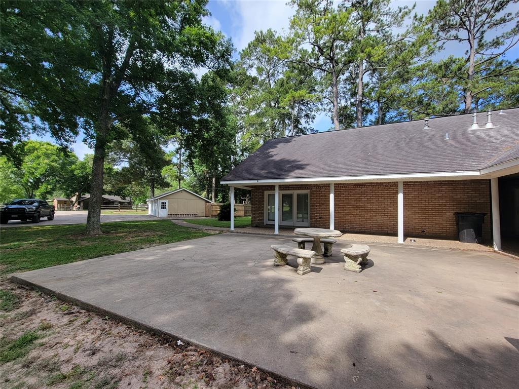 a view of backyard with table and chairs and a fire pit