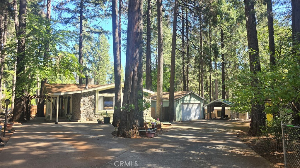 a front view of a house with a tree in front