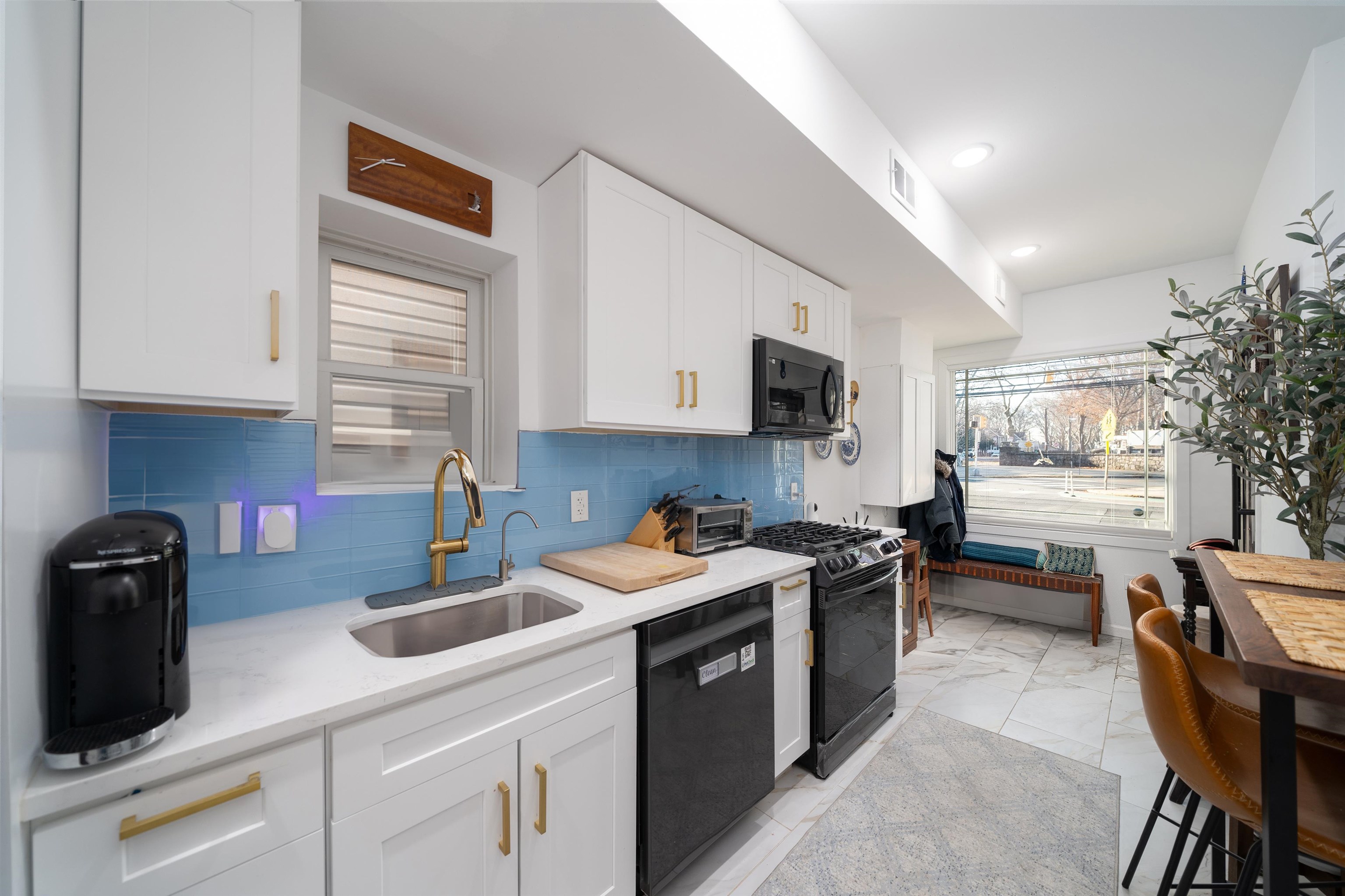 a kitchen with a sink a stove and cabinets