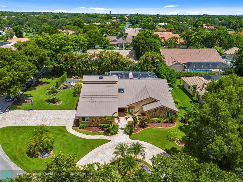 an aerial view of residential houses with outdoor space and street view