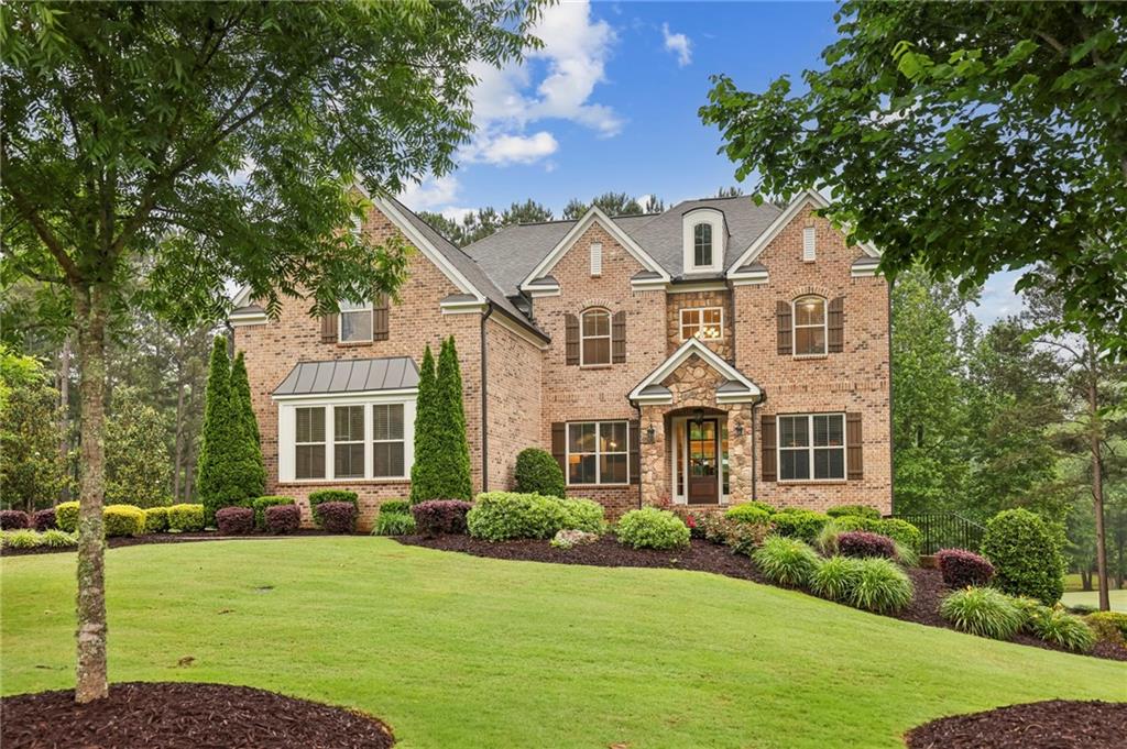 a front view of a house with a yard