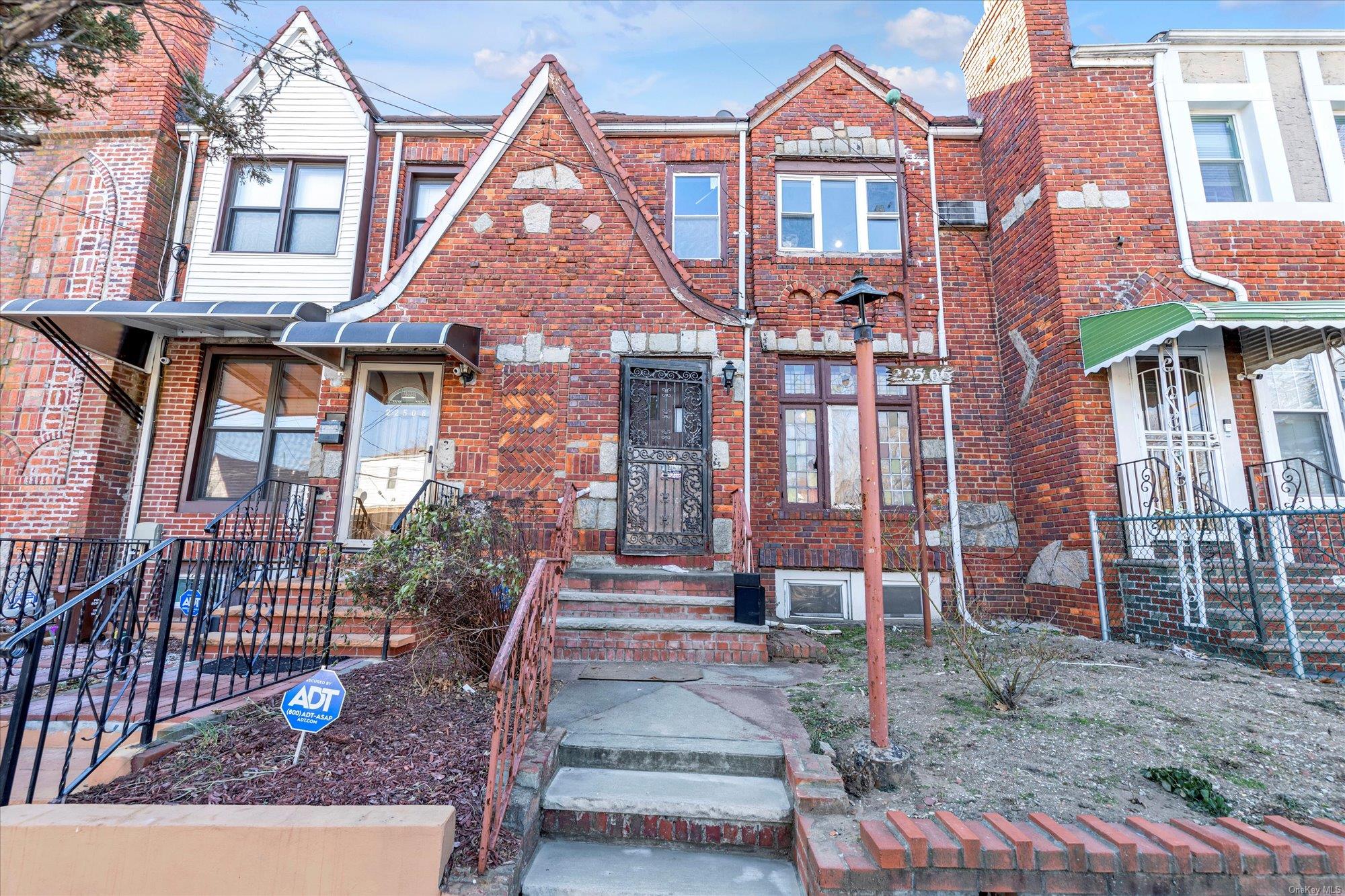 a front view of a brick house with a yard