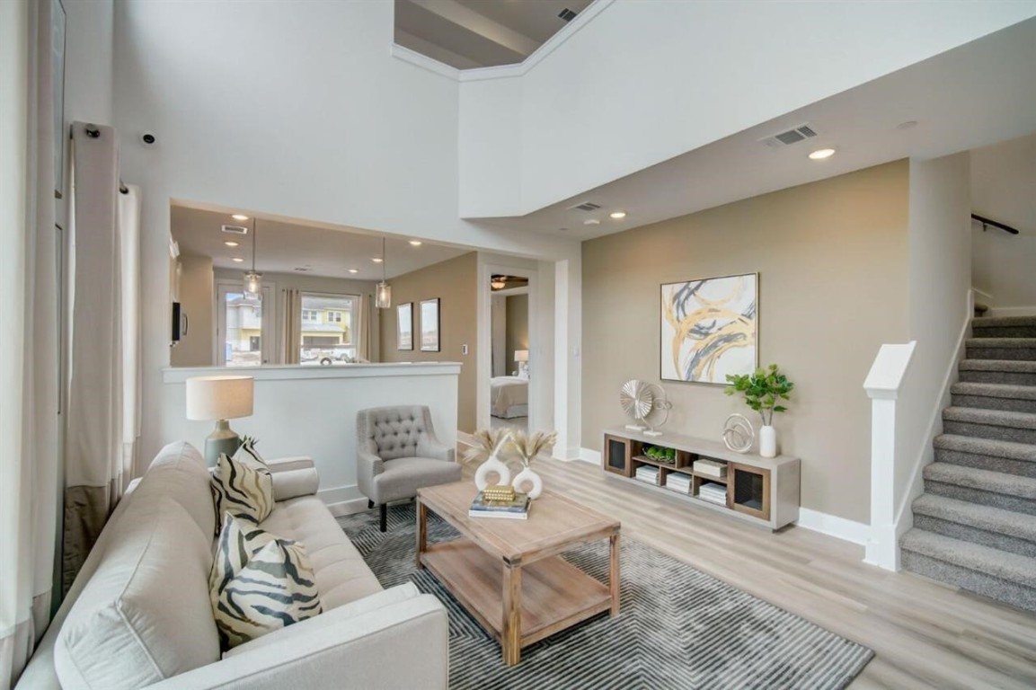 a living room with furniture and wooden floor