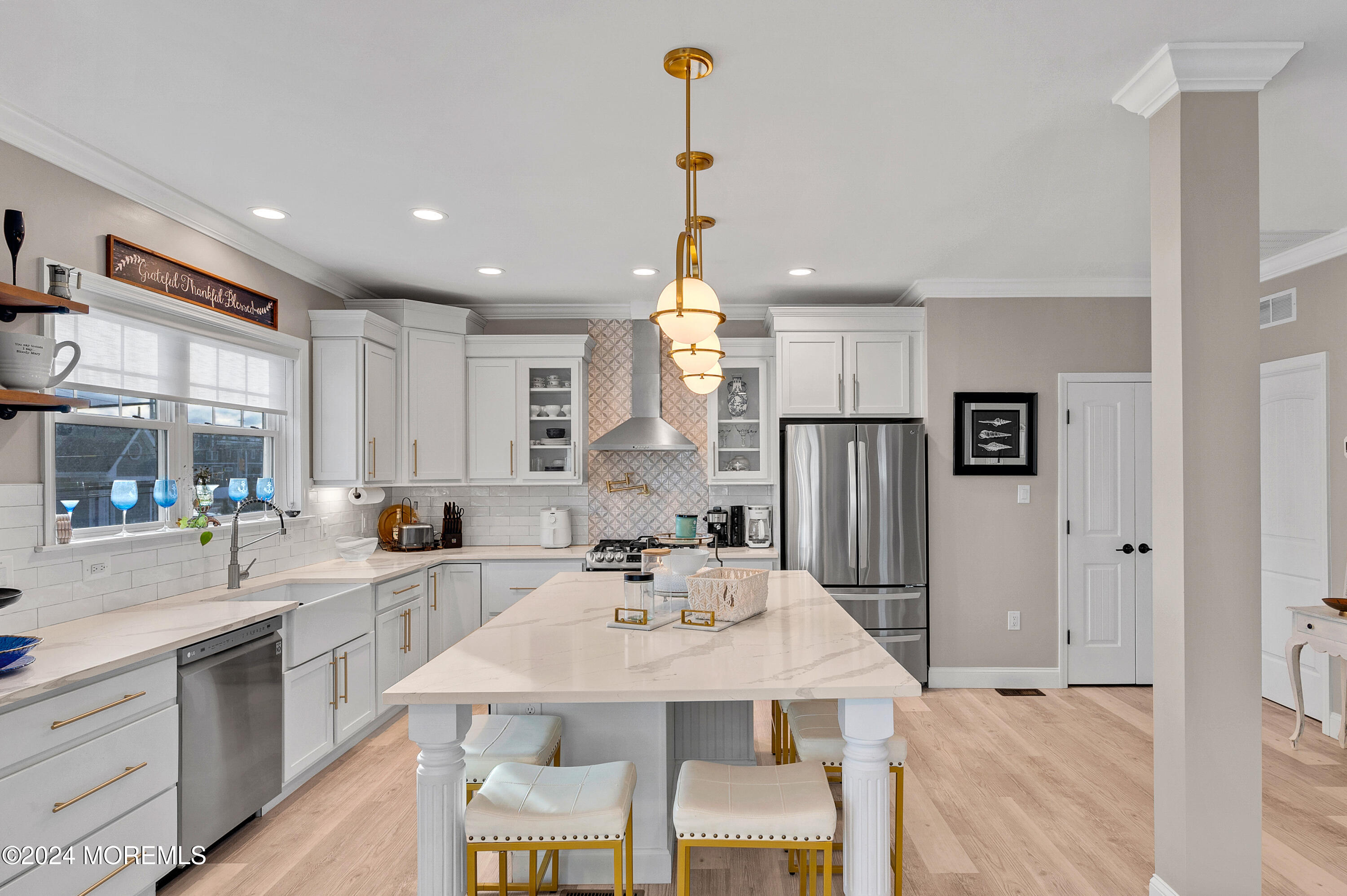 a kitchen with refrigerator a sink and chairs