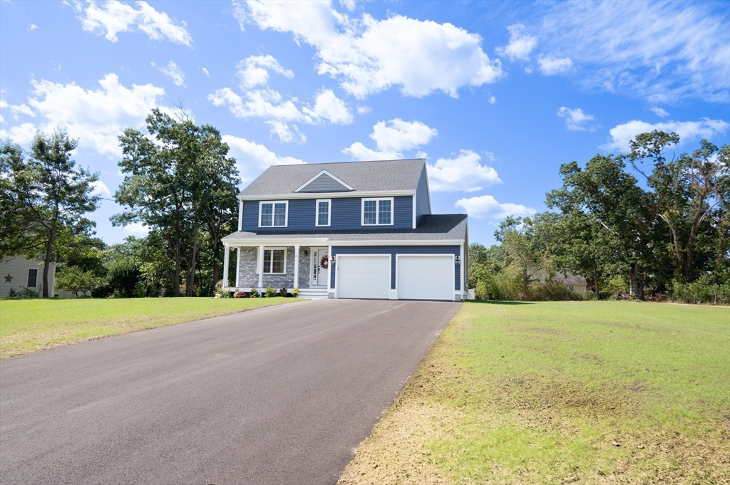 a view of a house with a big yard plants and trees