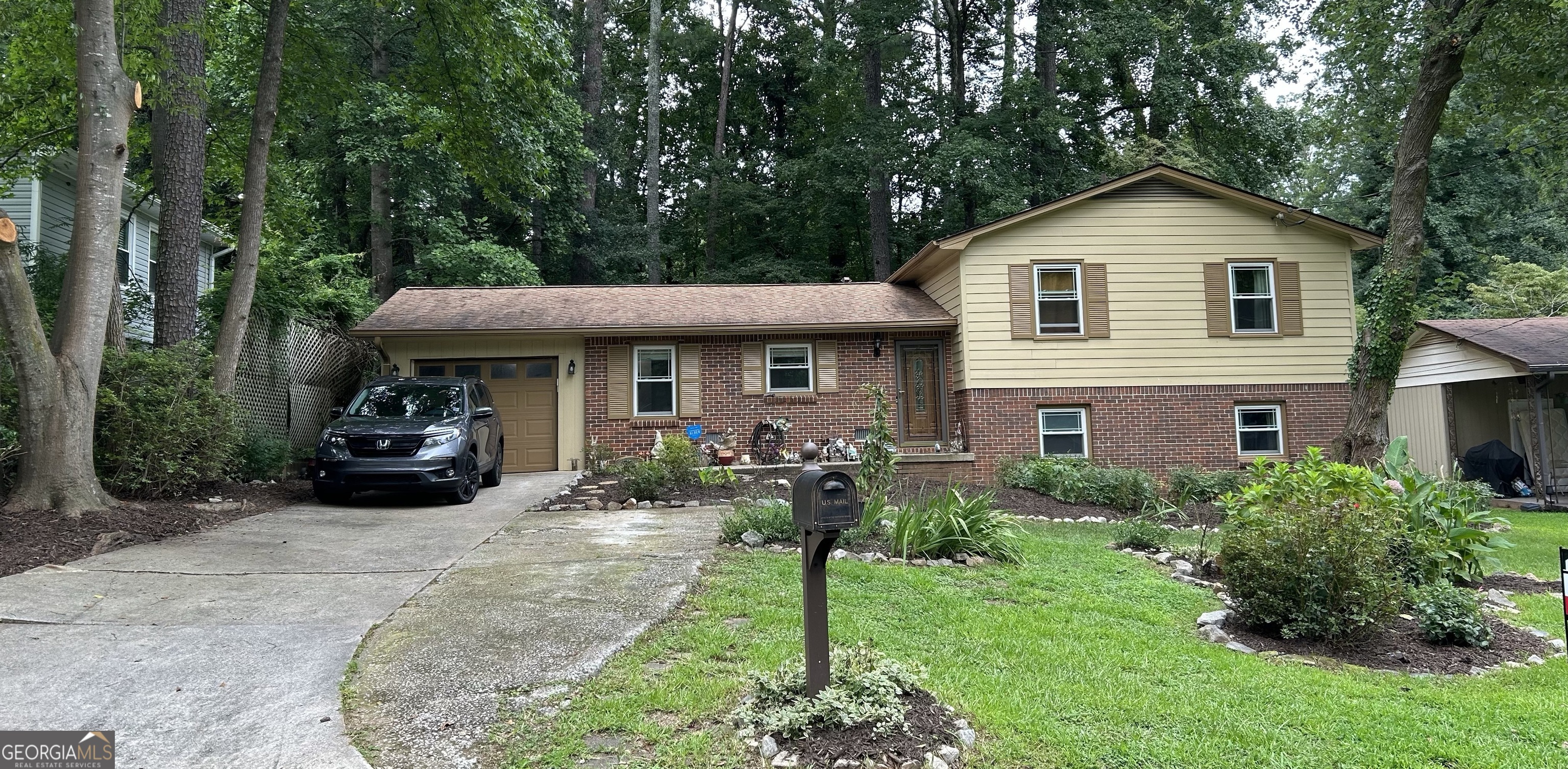 a front view of a house with a garden and porch