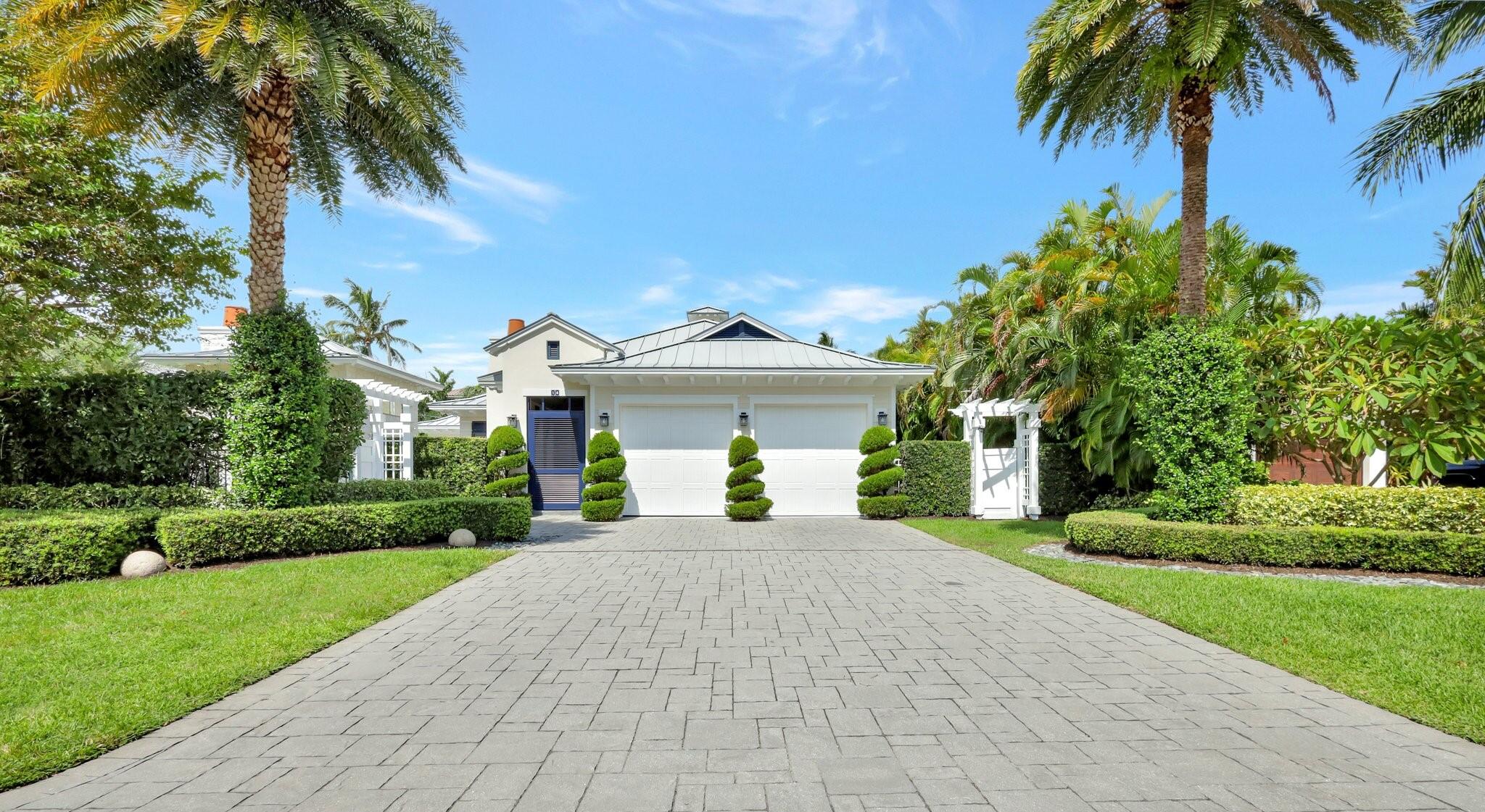 a front view of a house with a garden and a yard