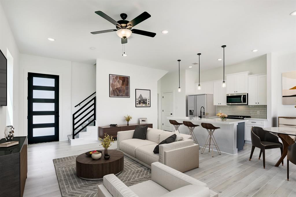 a living room with furniture a wooden floor and chandelier