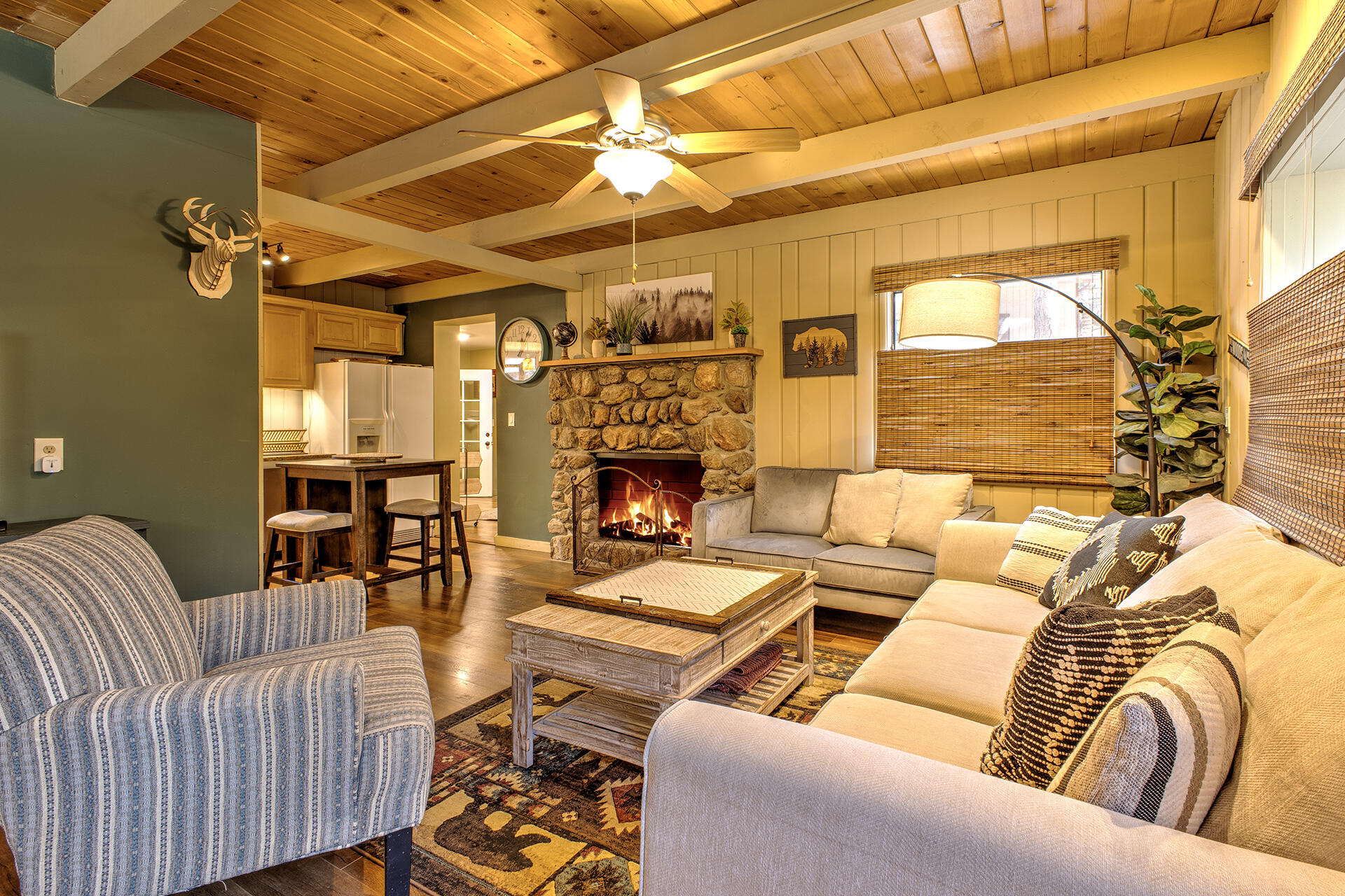 a living room with furniture a fireplace and a city view