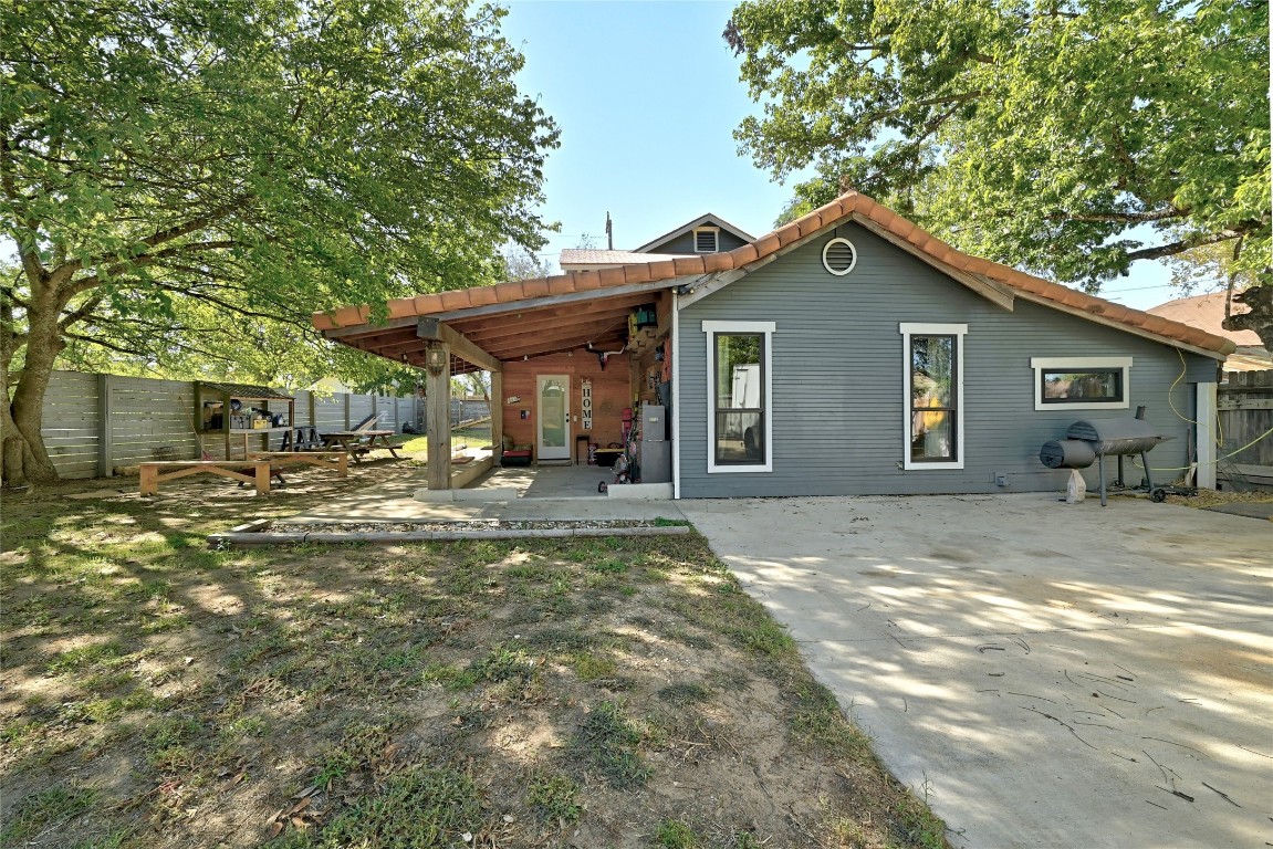 a view of a house with backyard and chairs