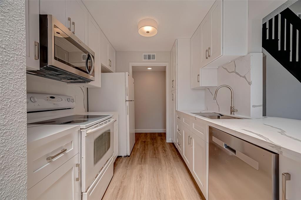 a kitchen with a sink stove and refrigerator