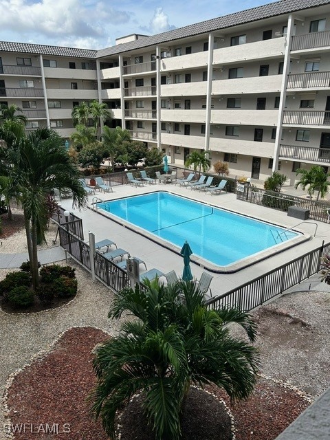 a view of pool with outdoor seating and plants