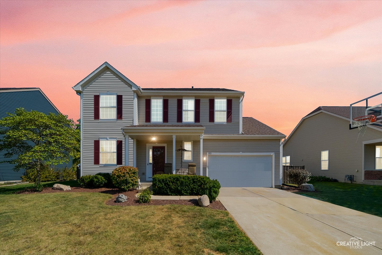 a front view of a house with yard and green space