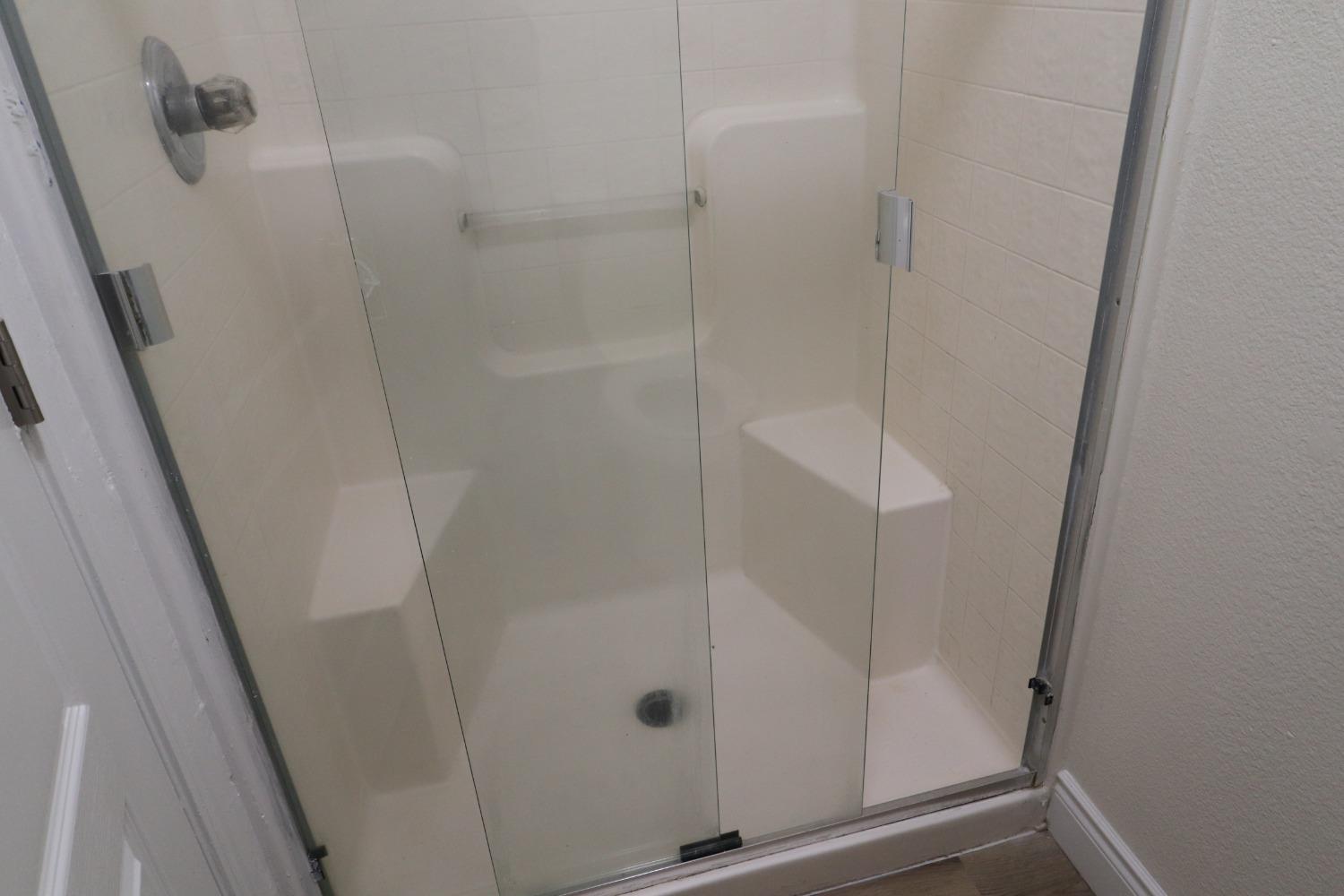 a bathroom with a glass shower door