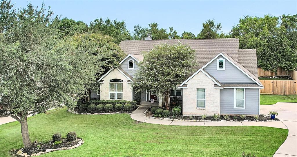 a front view of a house with a garden and yard