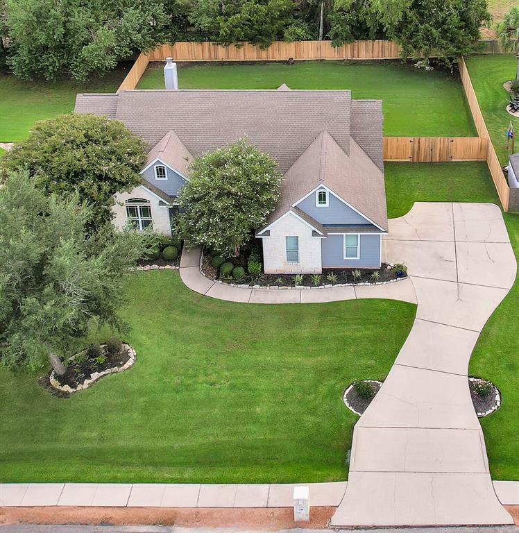 a aerial view of a house with a yard and a fountain