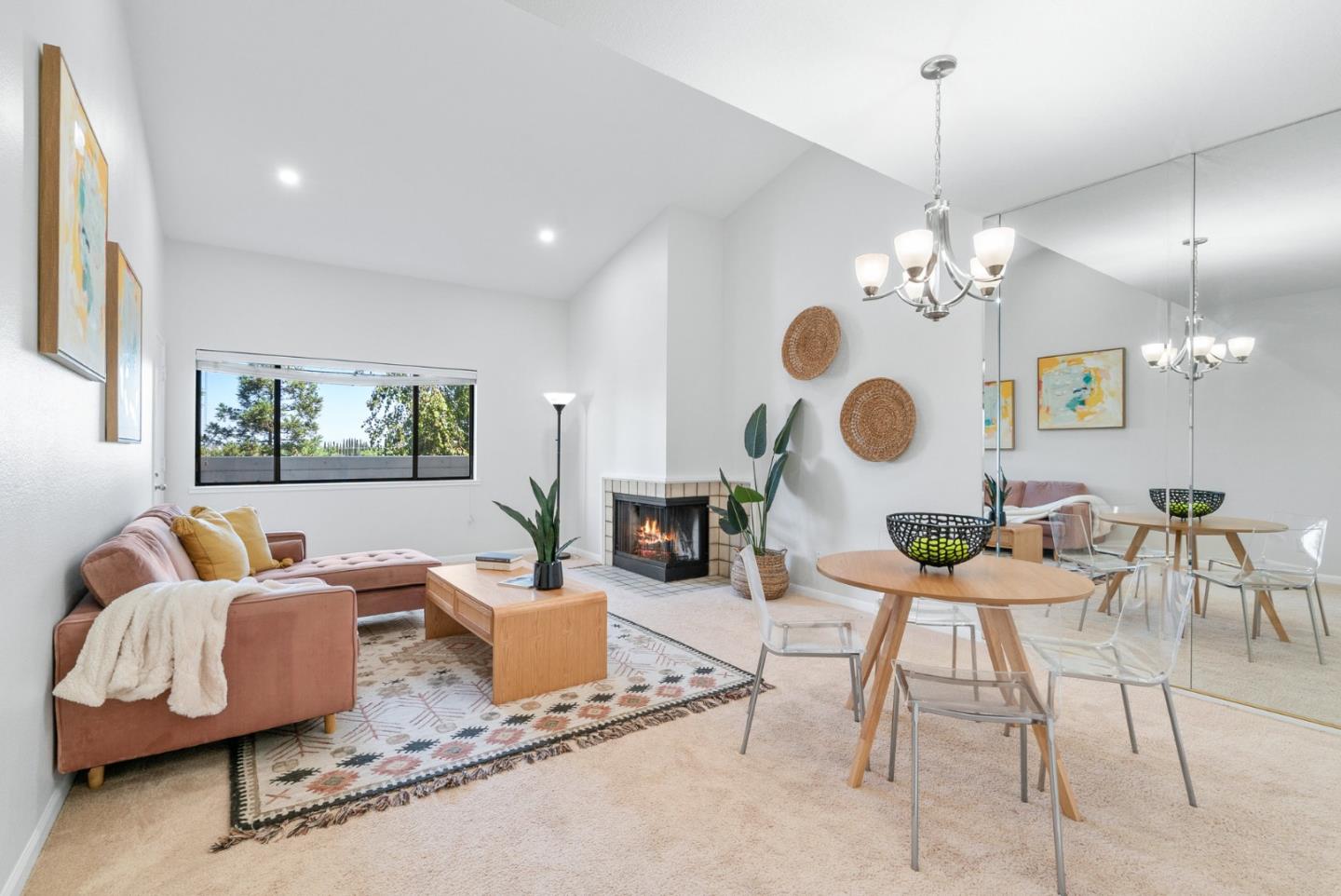 a living room with fireplace furniture and a chandelier