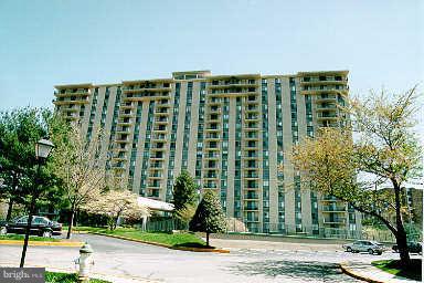 a front view of a building with a yard