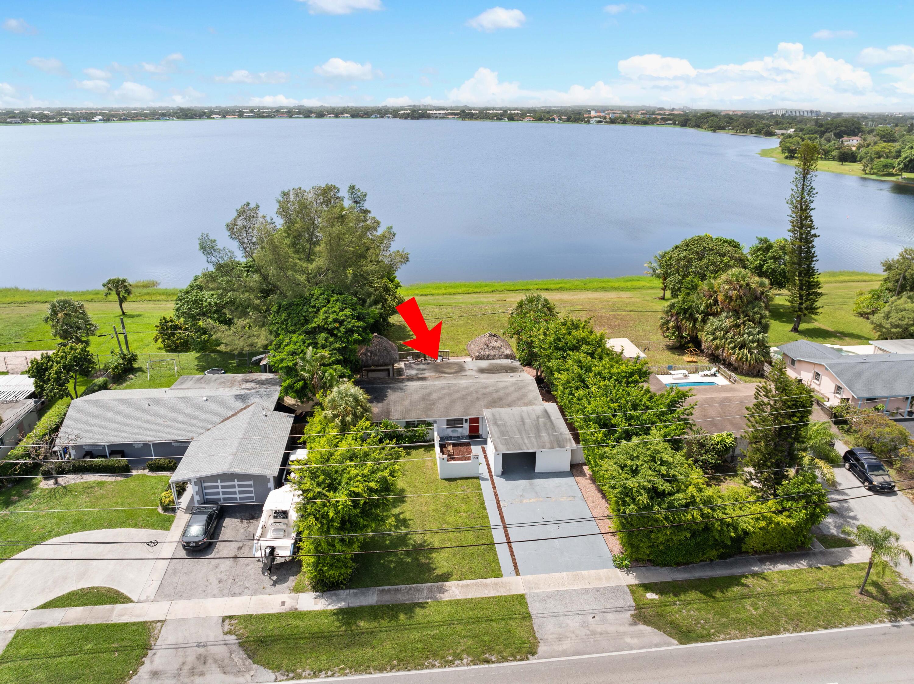 a aerial view of a house with a yard and lake view