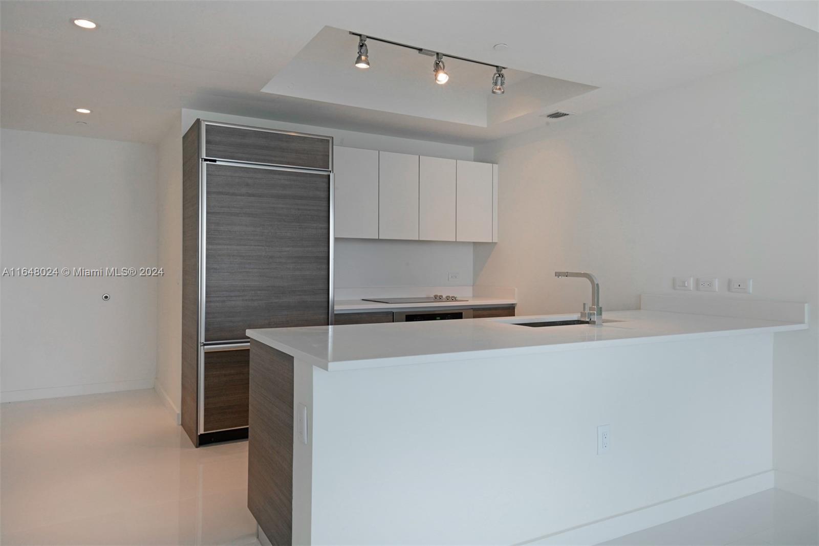 a kitchen with stainless steel appliances a sink stove and cabinets