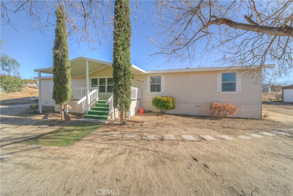 a view of a house with a yard and a garage