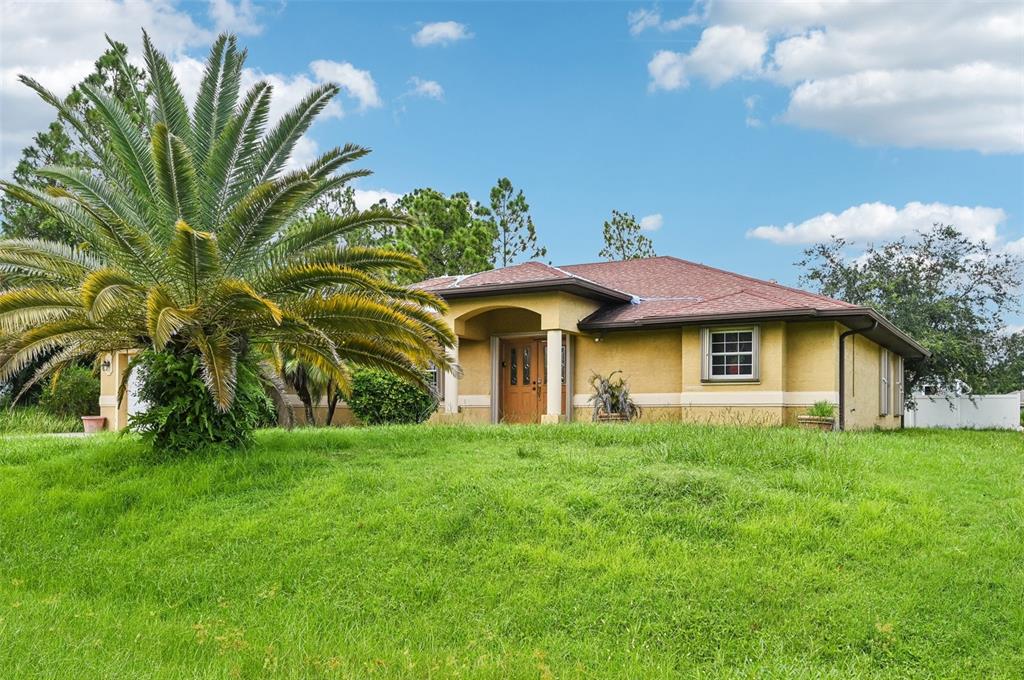 a front view of a house with a garden