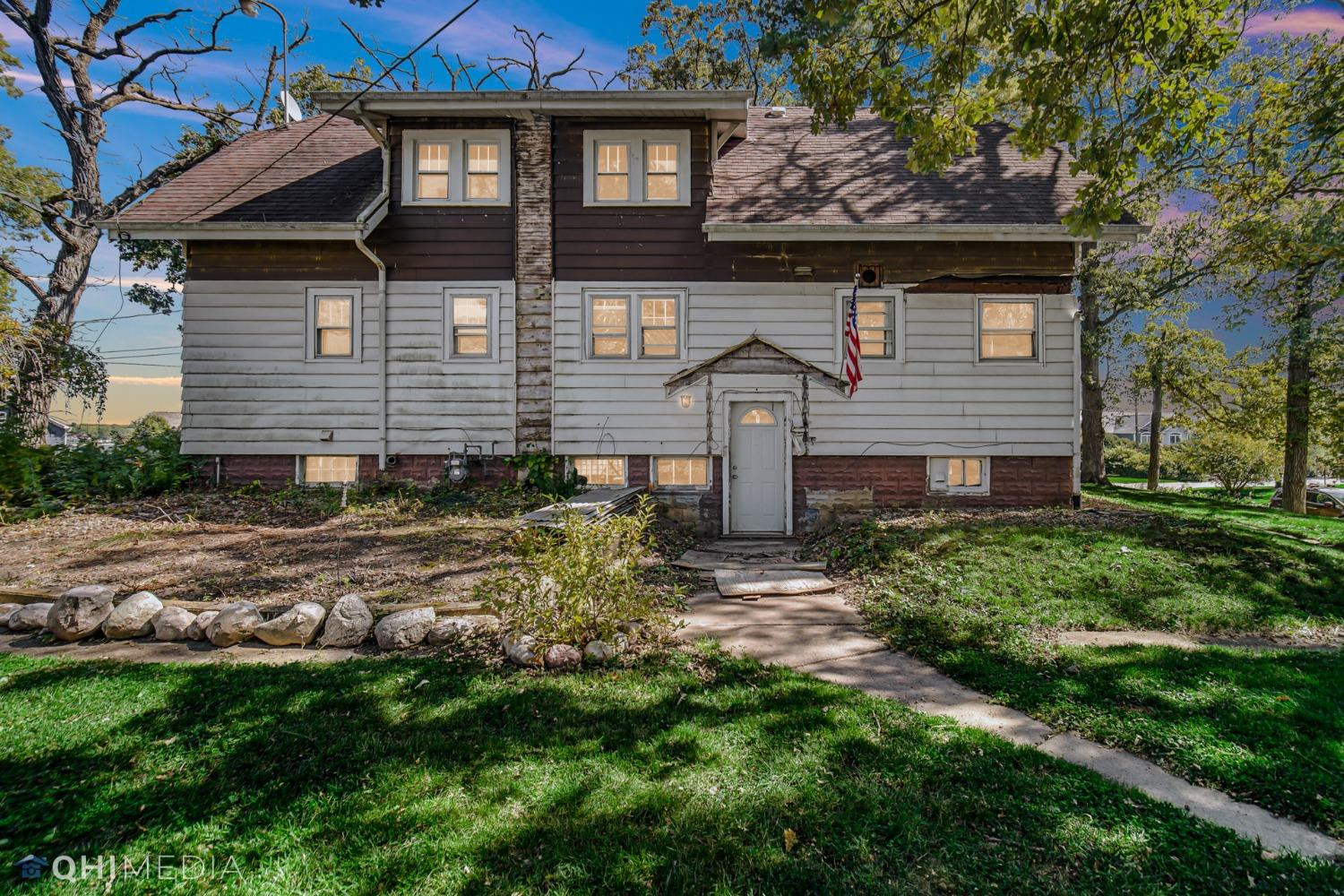 a front view of a house with garden