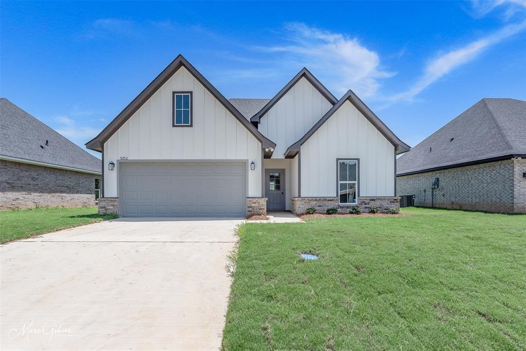 a front view of house with yard and outdoor seating