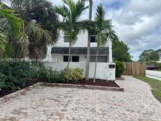 a front view of a house with a garden