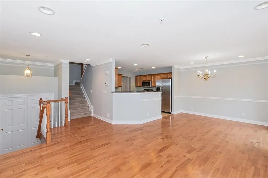 a view of kitchen with refrigerator and wooden floor